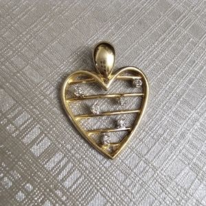 10k diamond heart pendant. Stamped 10k on the back. Genuine diamonds. Good size